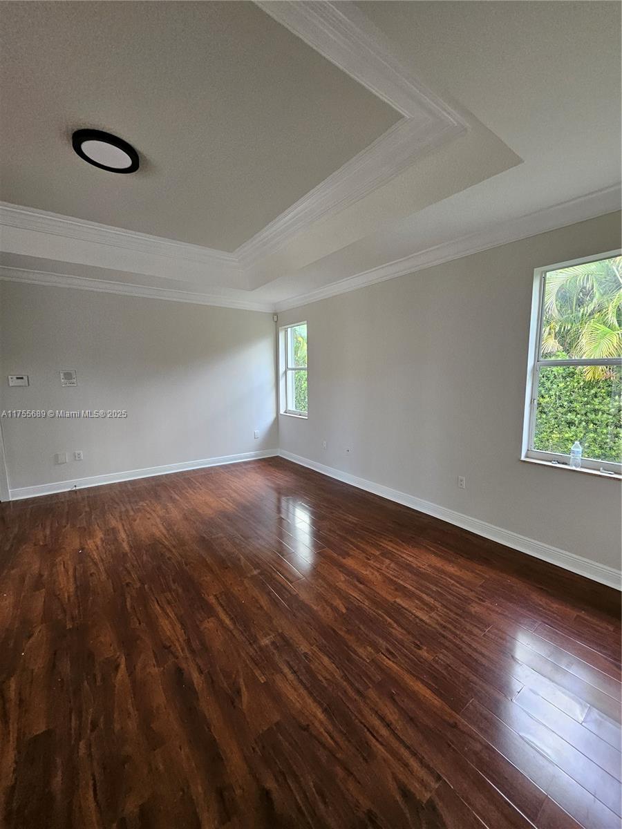 9491 Southwest 124th Terrace Miami, FL 33176 - Photo 18 of 26 a view of an empty room with wooden floor and a window