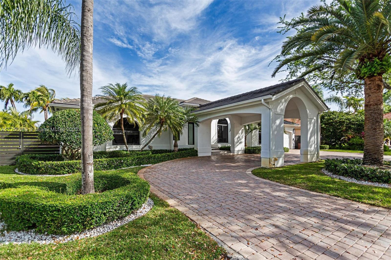 9491 Southwest 124th Terrace Miami, FL 33176 - Photo 2 of 26 a front view of a house with a garden and trees