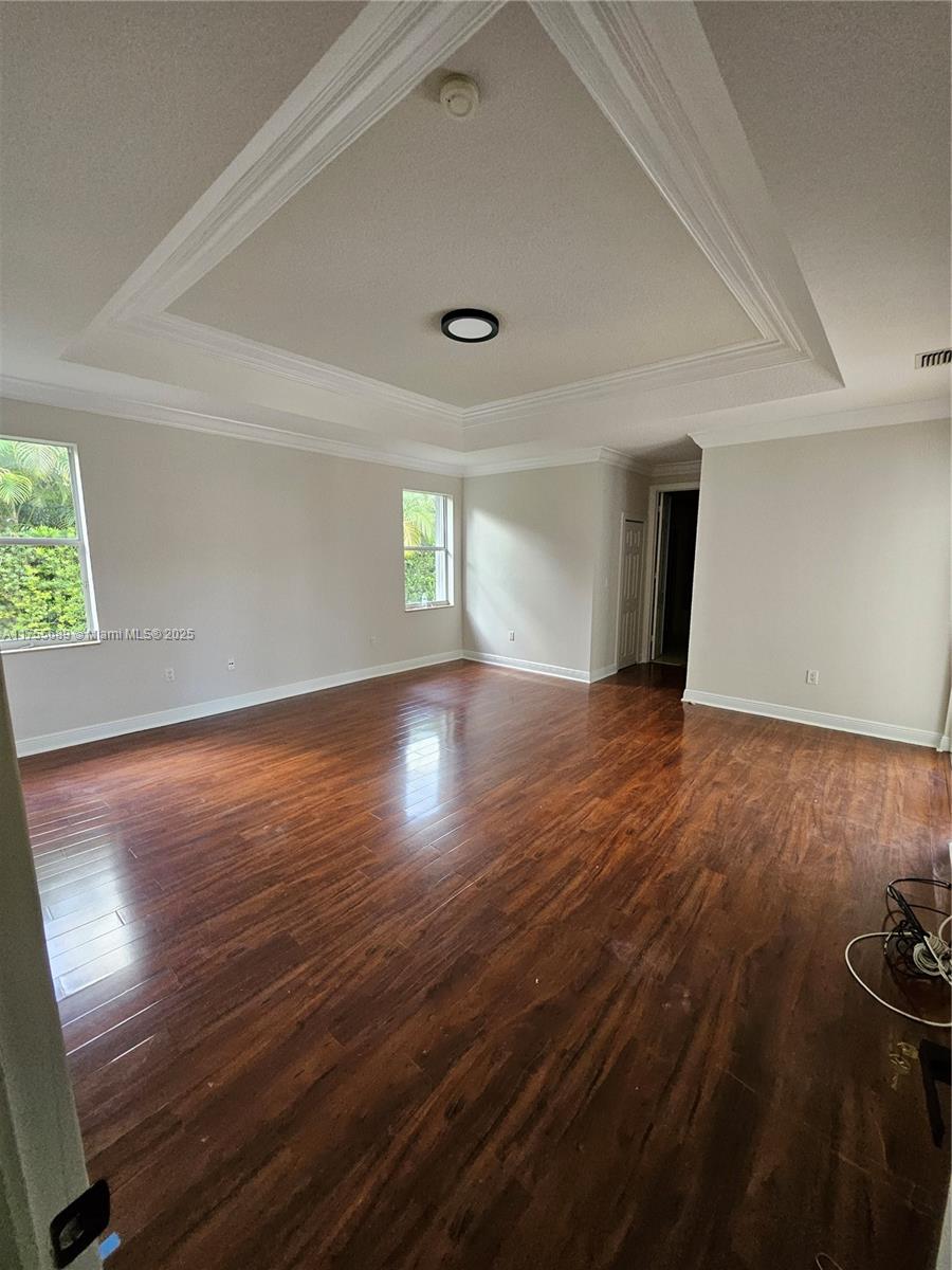 9491 Southwest 124th Terrace Miami, FL 33176 - Photo 22 of 26 a view of an empty room with wooden floor and a window
