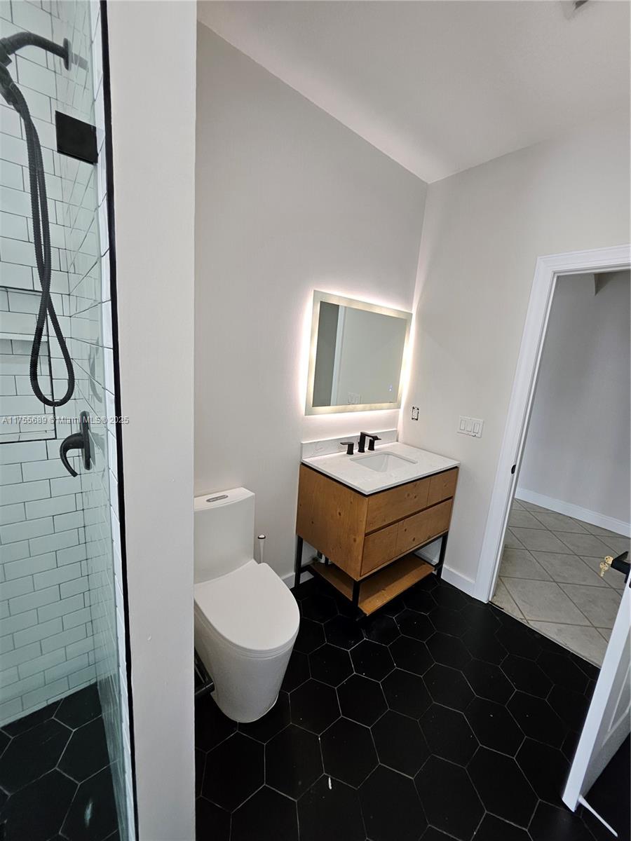 9491 Southwest 124th Terrace Miami, FL 33176 - Photo 23 of 26 a bathroom with a sink a toilet and mirror