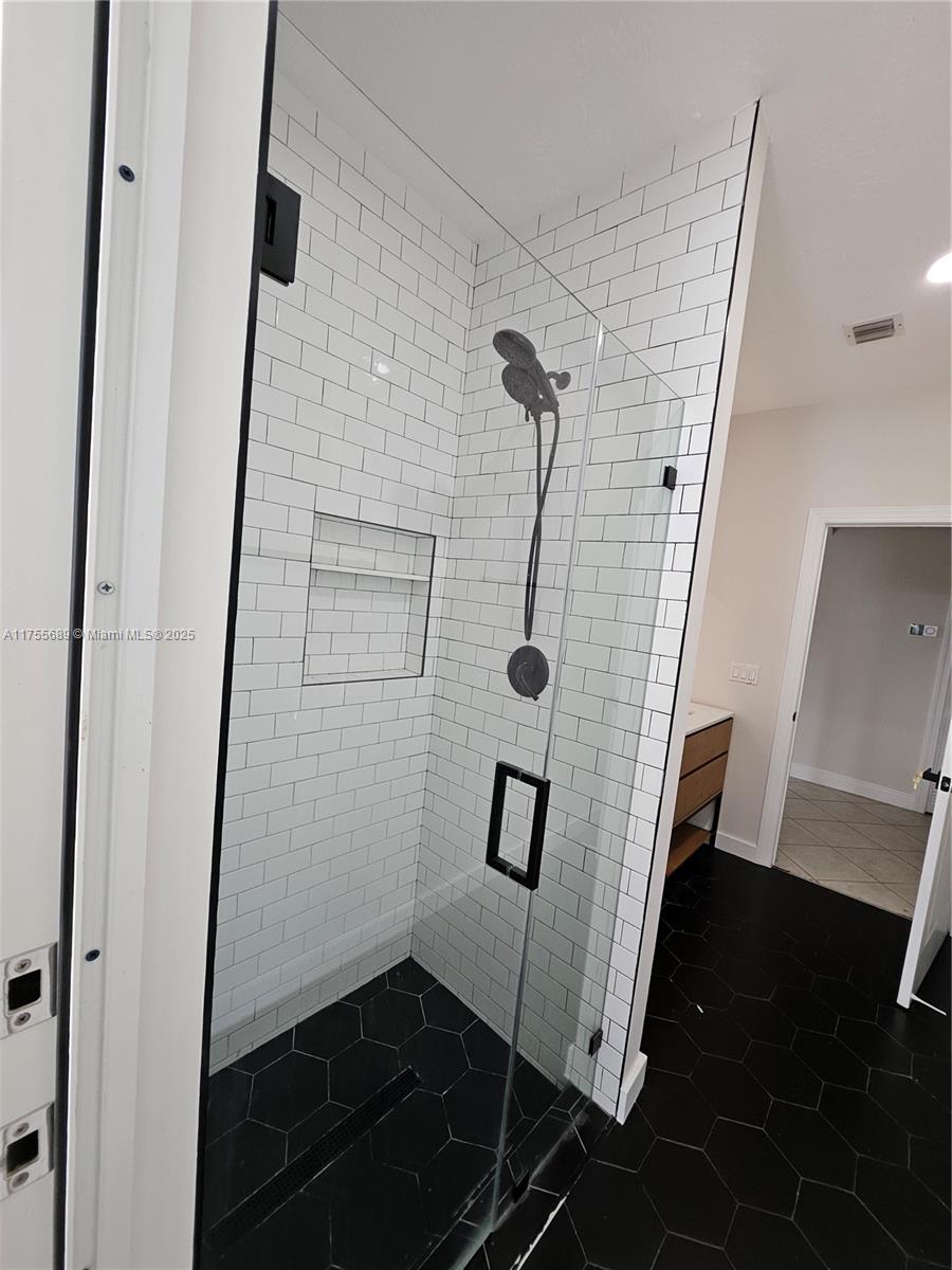 9491 Southwest 124th Terrace Miami, FL 33176 - Photo 24 of 26 a bathroom with a glass door shower