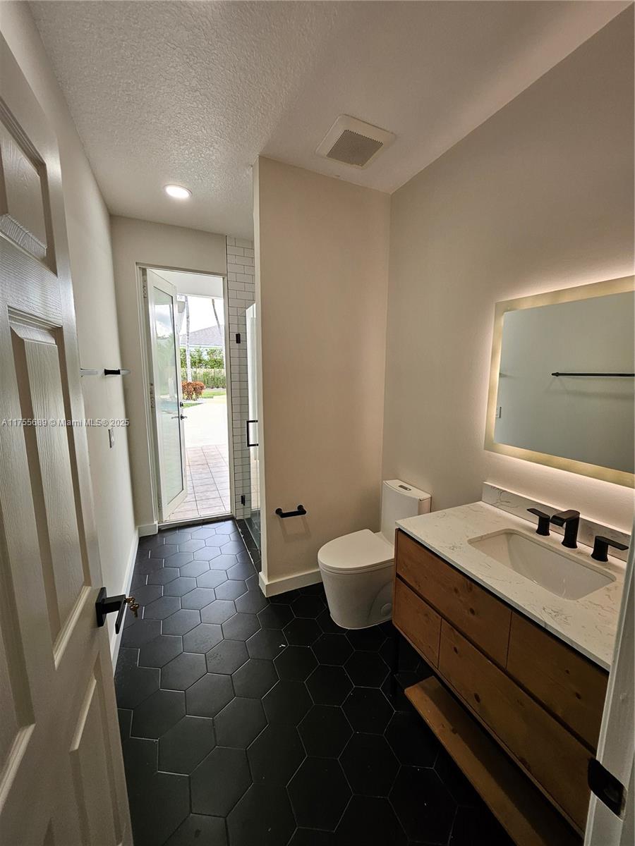 9491 Southwest 124th Terrace Miami, FL 33176 - Photo 25 of 26 a bathroom with a sink and a mirror