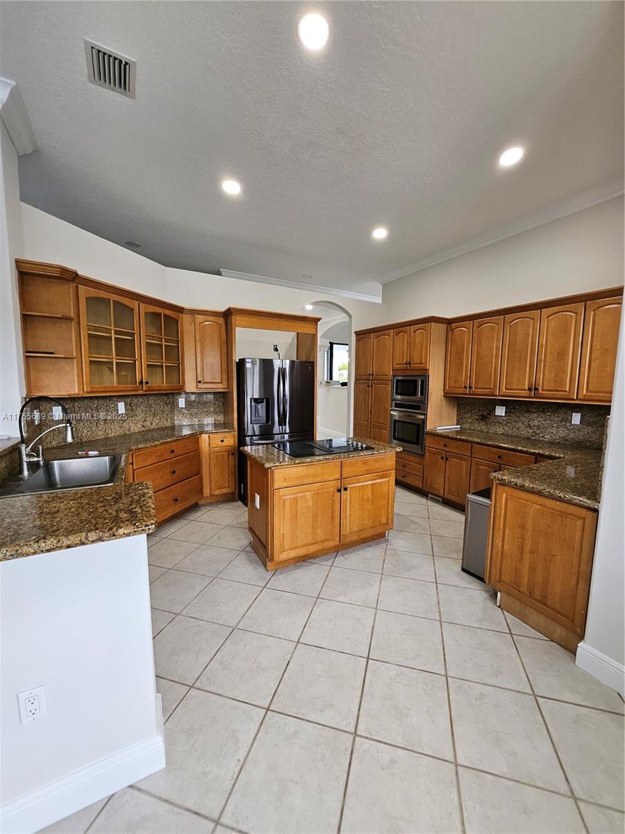 9491 Southwest 124th Terrace Miami, FL 33176 - Photo 26 of 26 a kitchen with stainless steel appliances granite countertop a sink and cabinets