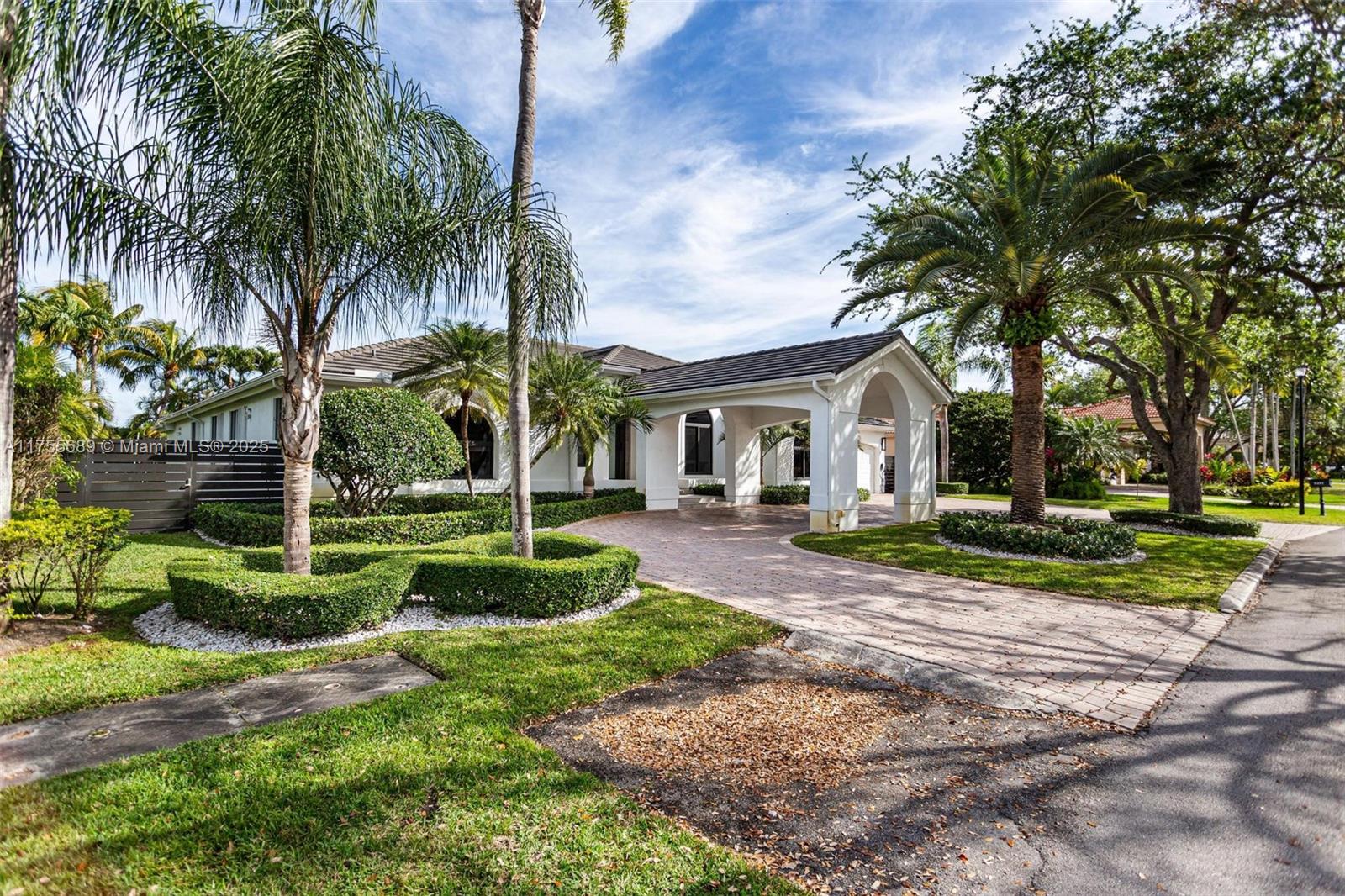 9491 Southwest 124th Terrace Miami, FL 33176 - Photo 3 of 26 a front view of a house with a yard and garage