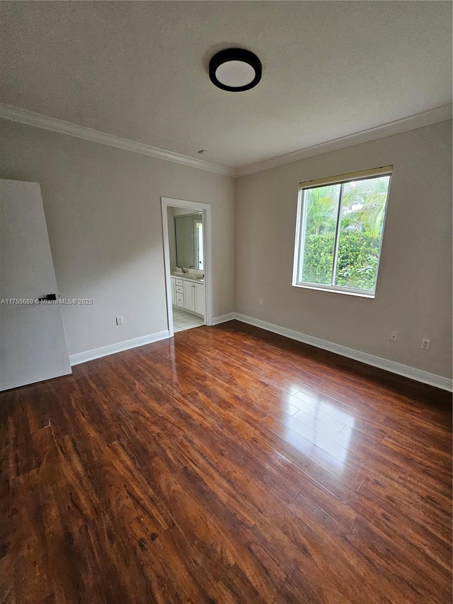 9491 Southwest 124th Terrace Miami, FL 33176 - Photo 10 of 26 an empty room with wooden floor and windows