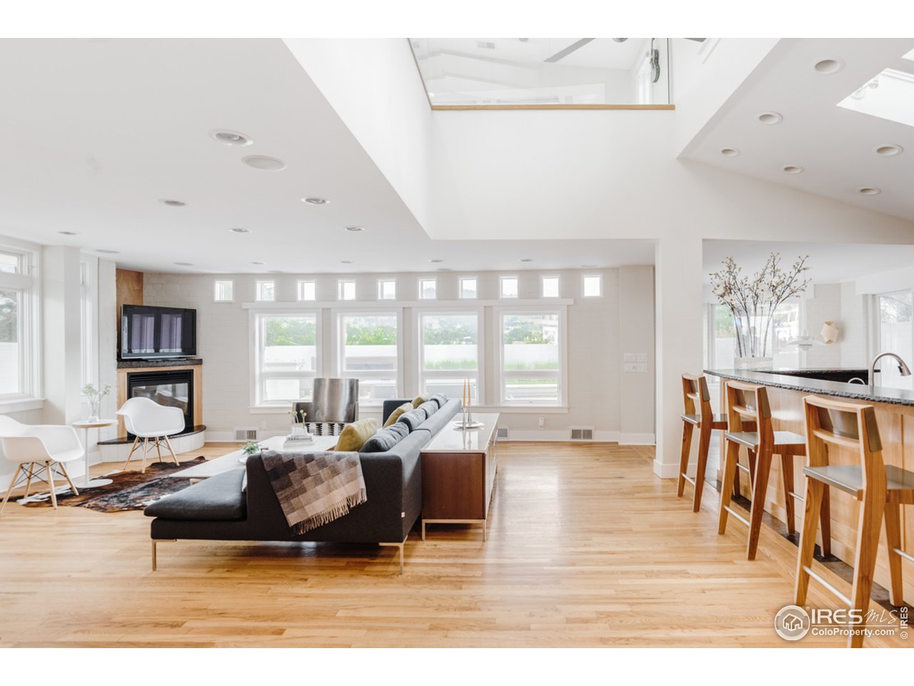 1491 High Street Boulder, CO 80304 - Photo 11 of 40 a living room with furniture large window and wooden floor