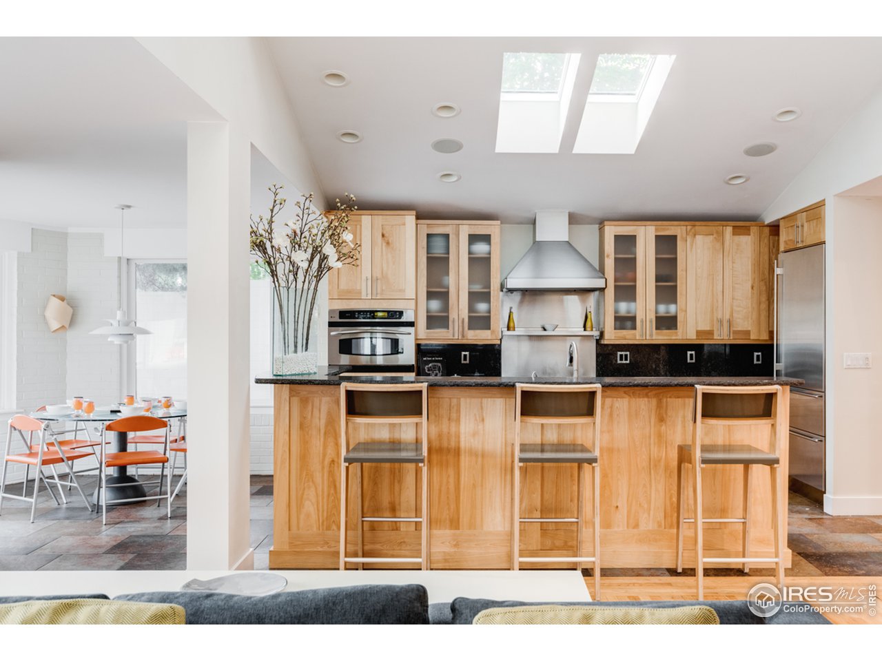 1491 High Street Boulder, CO 80304 - Photo 12 of 40 a kitchen with stainless steel appliances kitchen island granite countertop a refrigerator and a stove top oven
