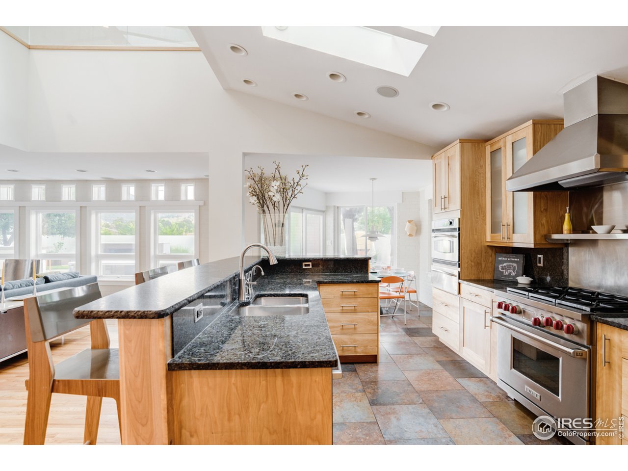 1491 High Street Boulder, CO 80304 - Photo 17 of 40 a kitchen with granite countertop a stove and cabinets