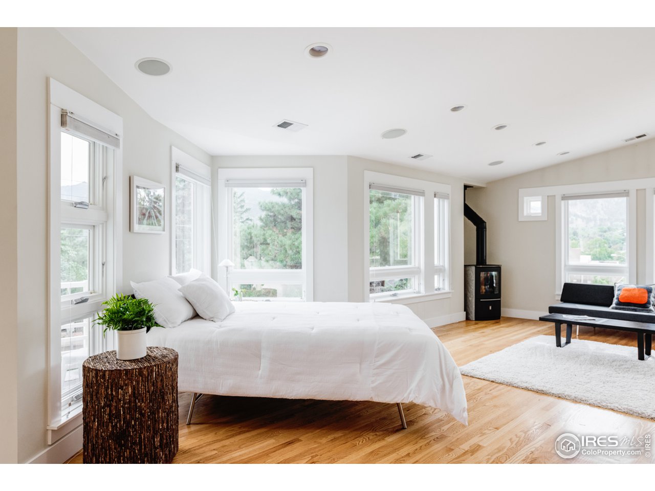 1491 High Street Boulder, CO 80304 - Photo 24 of 40 a bedroom with a bed and large windows