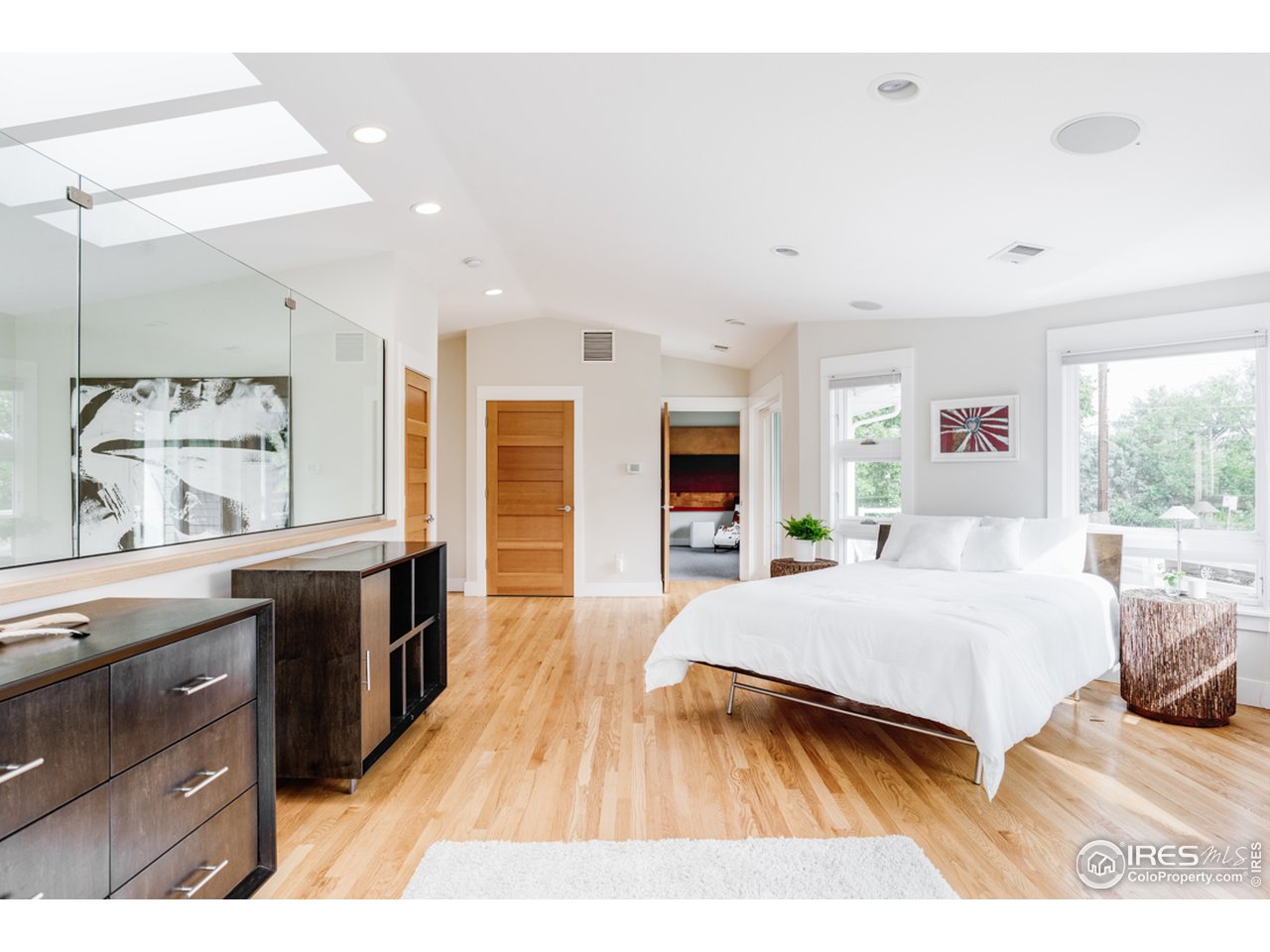 1491 High Street Boulder, CO 80304 - Photo 26 of 40 a spacious bedroom with a bed and wooden floor