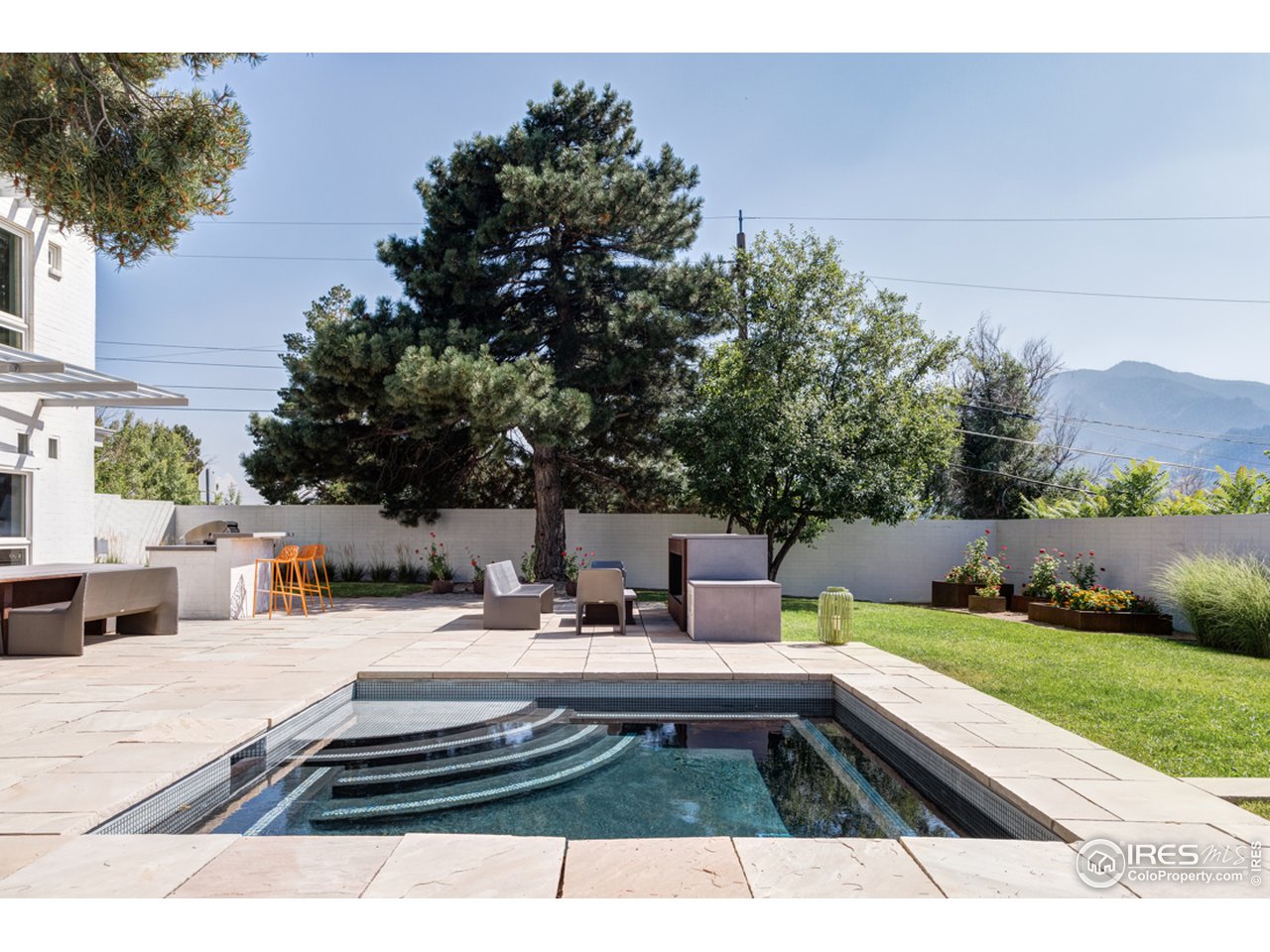 1491 High Street Boulder, CO 80304 - Photo 6 of 40 a view of swimming pool with seating space and trees in the background