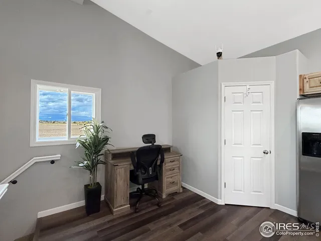 a view of a workspace with furniture and a potted plant