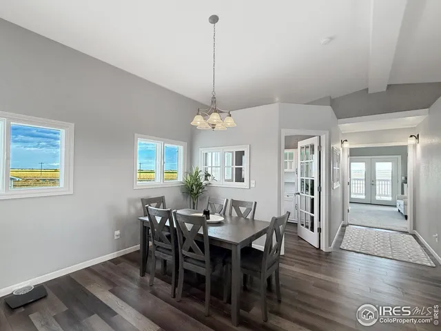 a view of a a dining room with furniture window and wooden floor