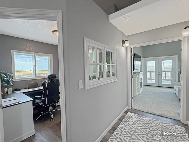 a view of workspace with wooden floor and windows