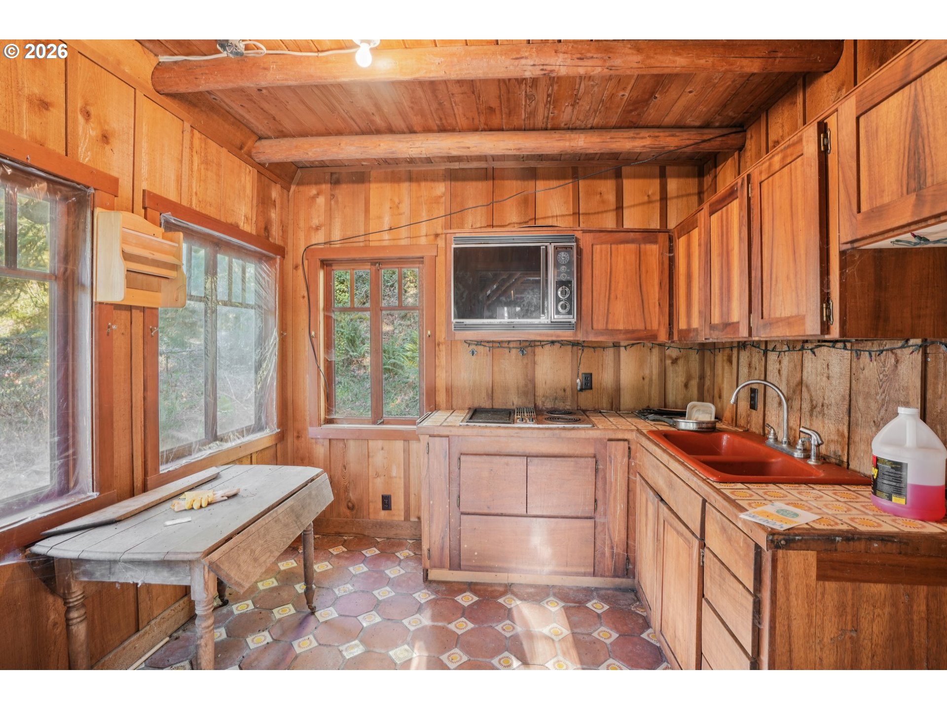 63875 East Barlow Trail Road Rhododendron, OR 97049 - Photo 8 of 17 a kitchen with a stove a sink and a microwave