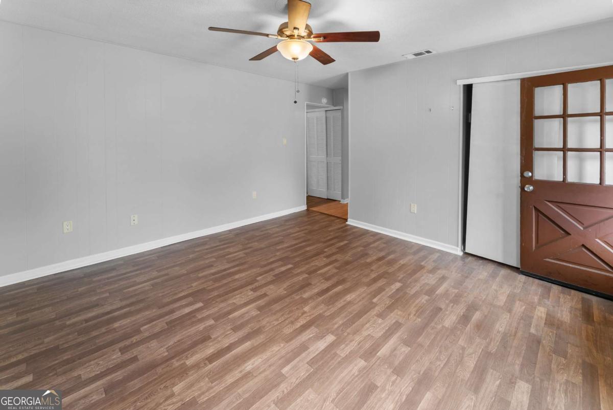 320 West Whatley Street Pooler, GA 31322 - Photo 9 of 34 wooden floor in an empty room with a window