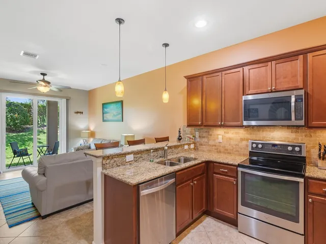 a kitchen with a stove a sink and a microwave