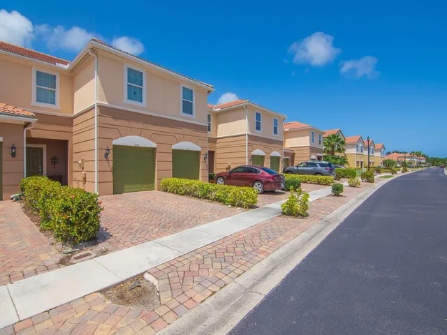 a front view of a house with a yard and outdoor seating