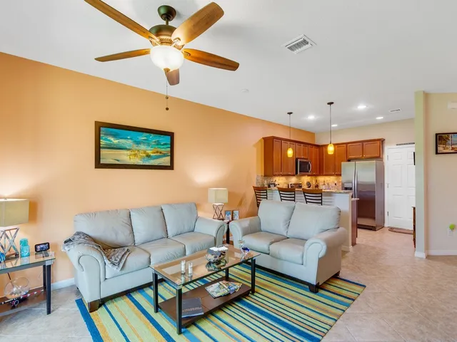 a living room with furniture and a view of kitchen