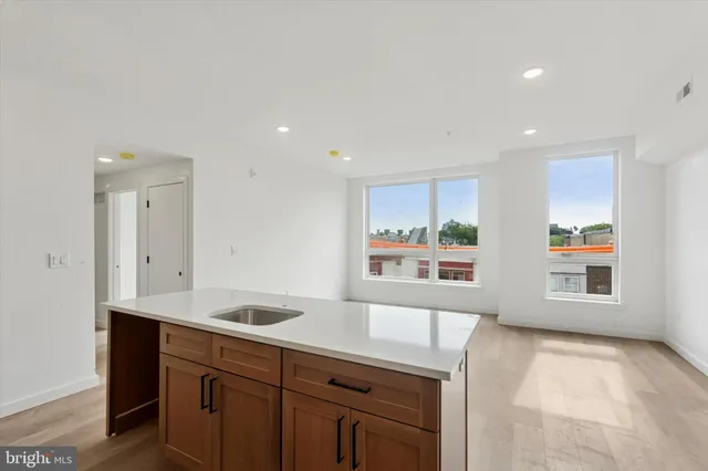 a view of a kitchen with a sink and window