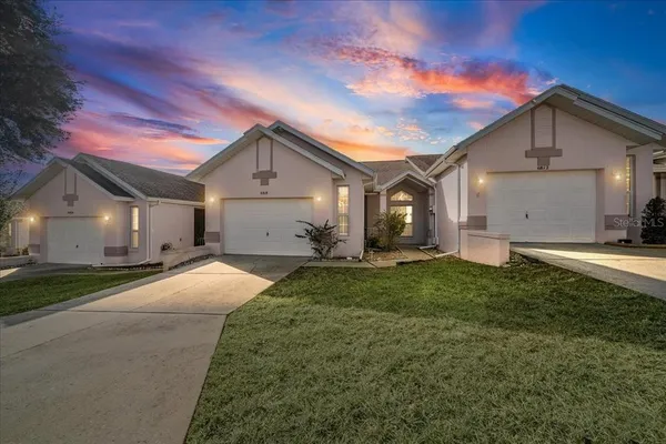 a view of a house with a yard and garage
