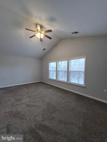 a spacious bathroom with a tub sink and mirror