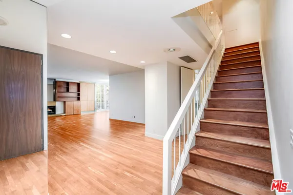 a view of entryway and hall with wooden floor