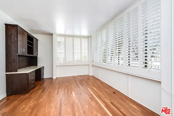 a view of a room with wooden floor and a window
