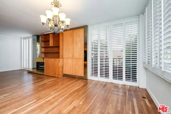 a view of a livingroom with wooden floor and staircase