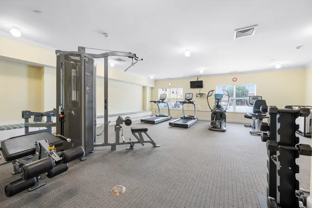 a view of a patio with a dining table and chairs with a small yard