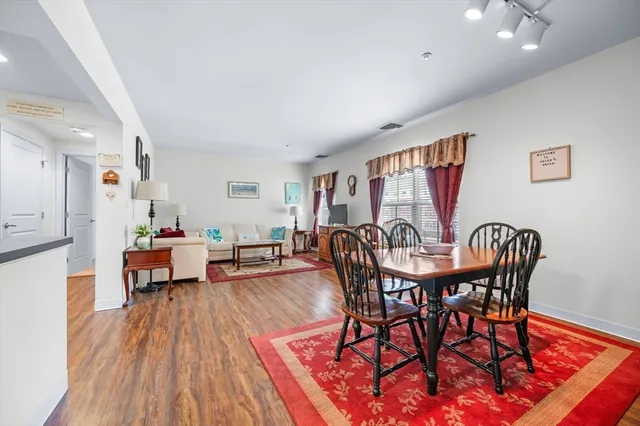 a view of a dining room with furniture window and wooden floor