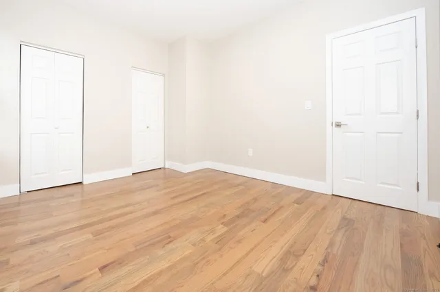 an empty room with wooden floor