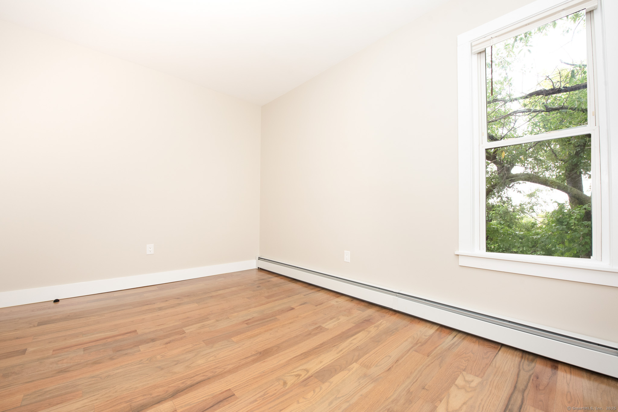 527 East Main Street Bridgeport, CT 06608 - Photo 13 of 25 an empty room with wooden floor and windows