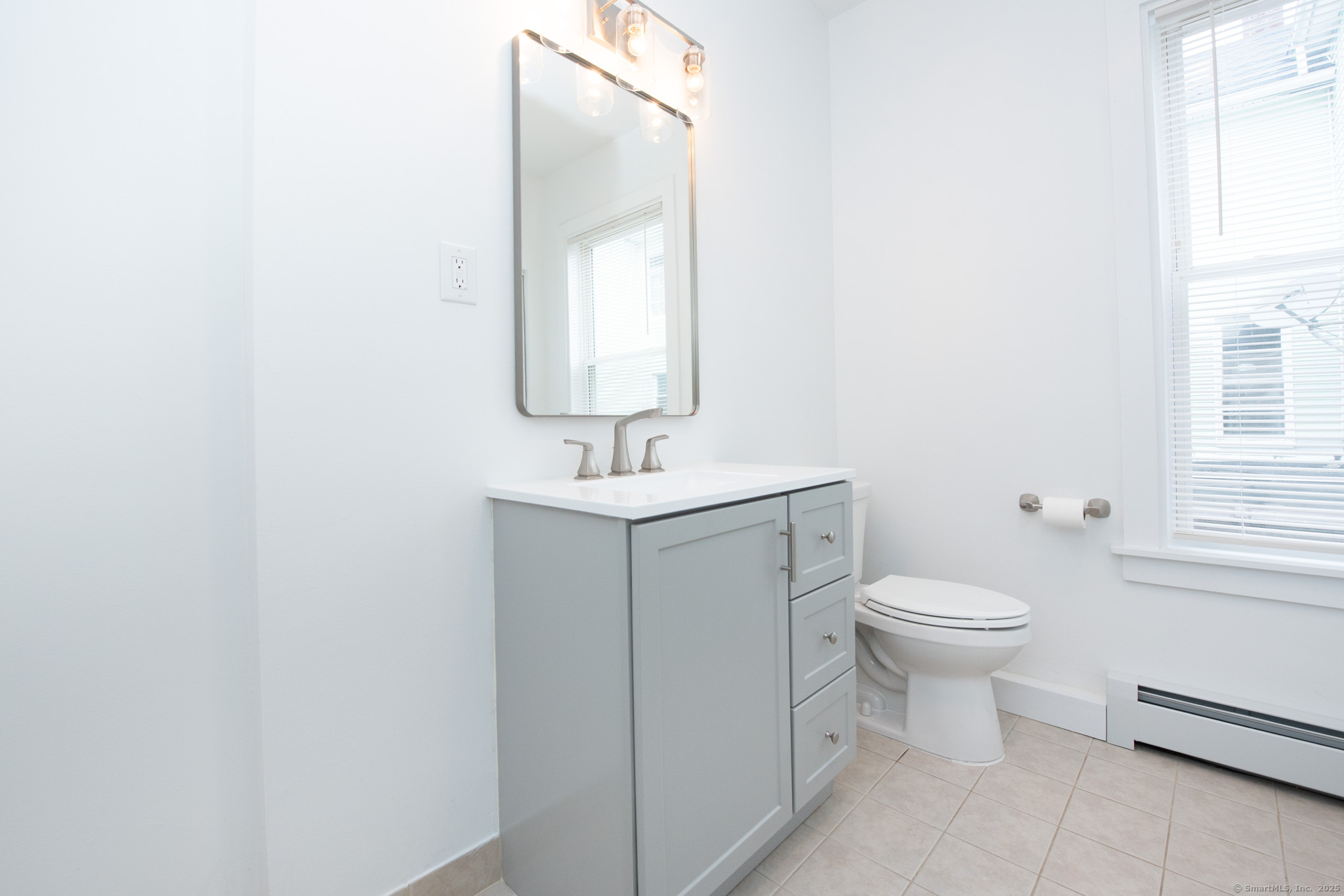 527 East Main Street Bridgeport, CT 06608 - Photo 15 of 25 a bathroom with a toilet sink and mirror