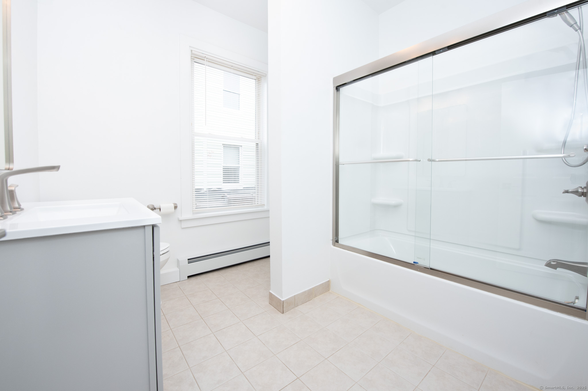 527 East Main Street Bridgeport, CT 06608 - Photo 18 of 25 a bathroom with a sink a toilet and shower