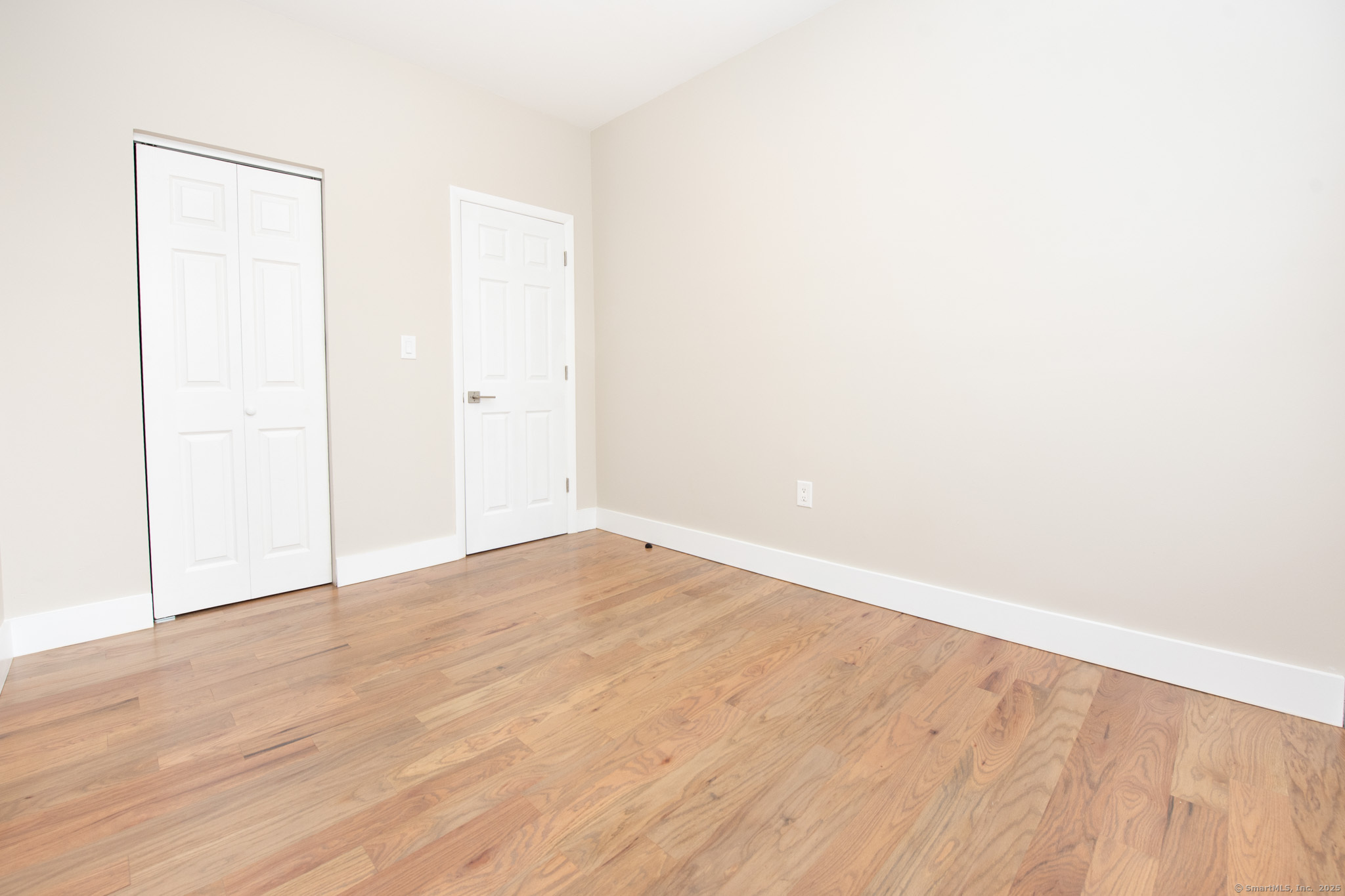 527 East Main Street Bridgeport, CT 06608 - Photo 21 of 25 a view of an empty room with wooden floor
