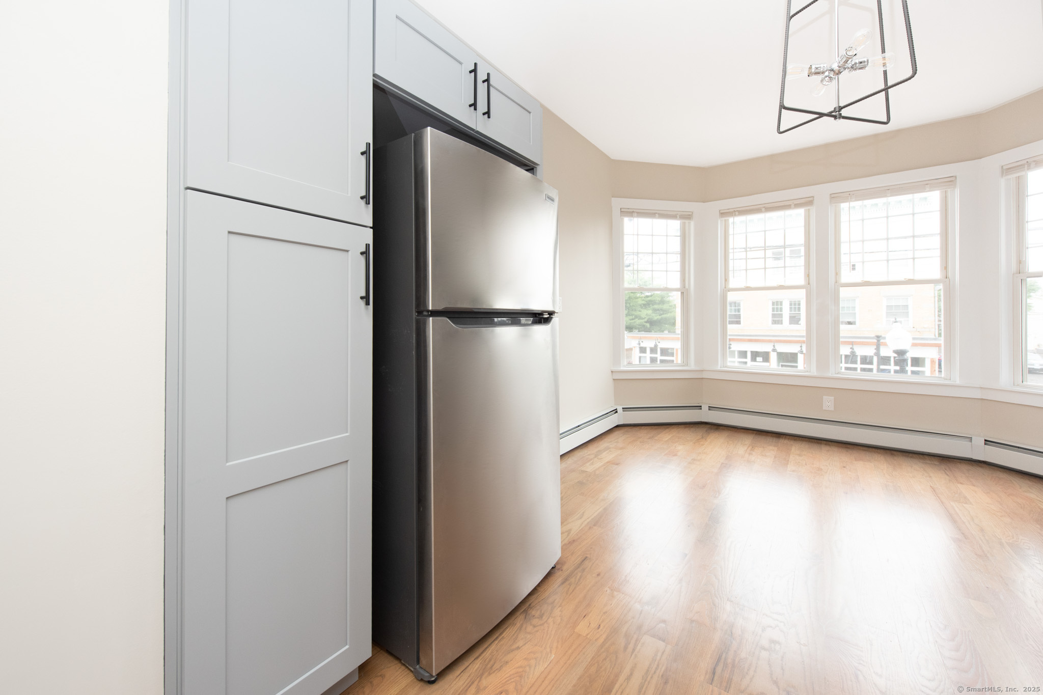 527 East Main Street Bridgeport, CT 06608 - Photo 5 of 25 a view of a kitchen with a refrigerator cabinets and wooden floor