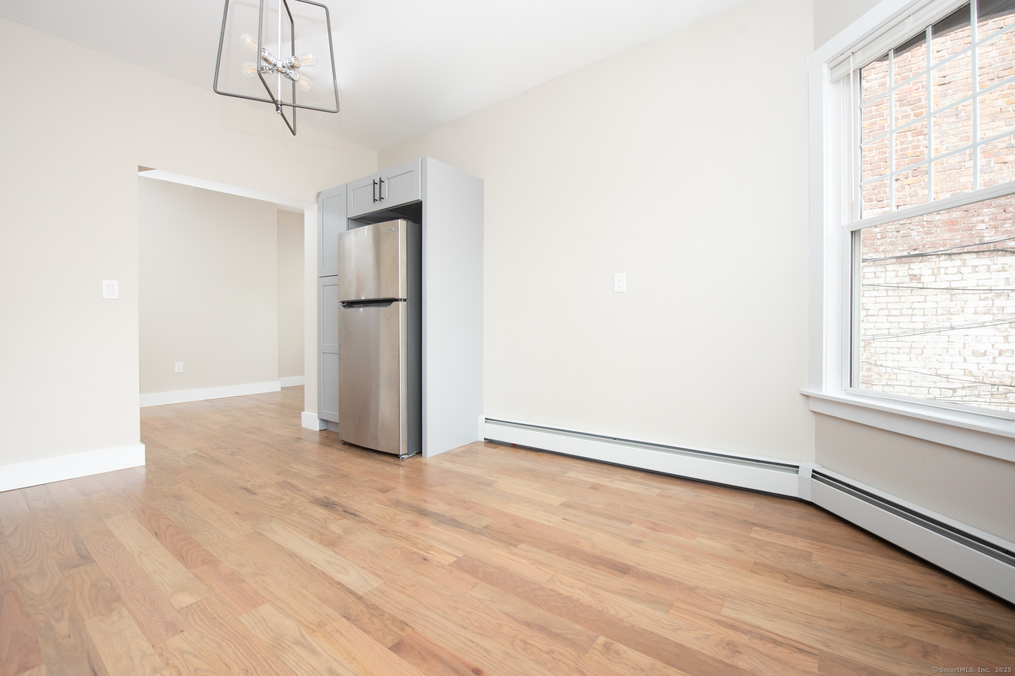 527 East Main Street Bridgeport, CT 06608 - Photo 6 of 25 a view of an empty room with wooden floor and a window