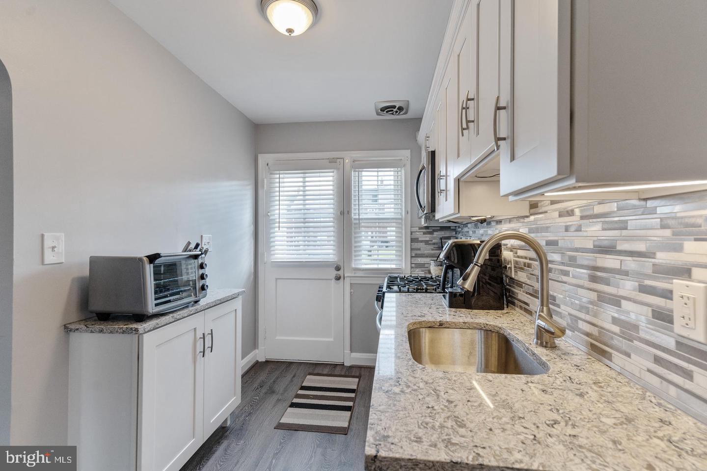 1067 Elm Road Halethorpe, MD 21227 - Photo 11 of 32 a kitchen with stainless steel appliances a sink a stove and a refrigerator