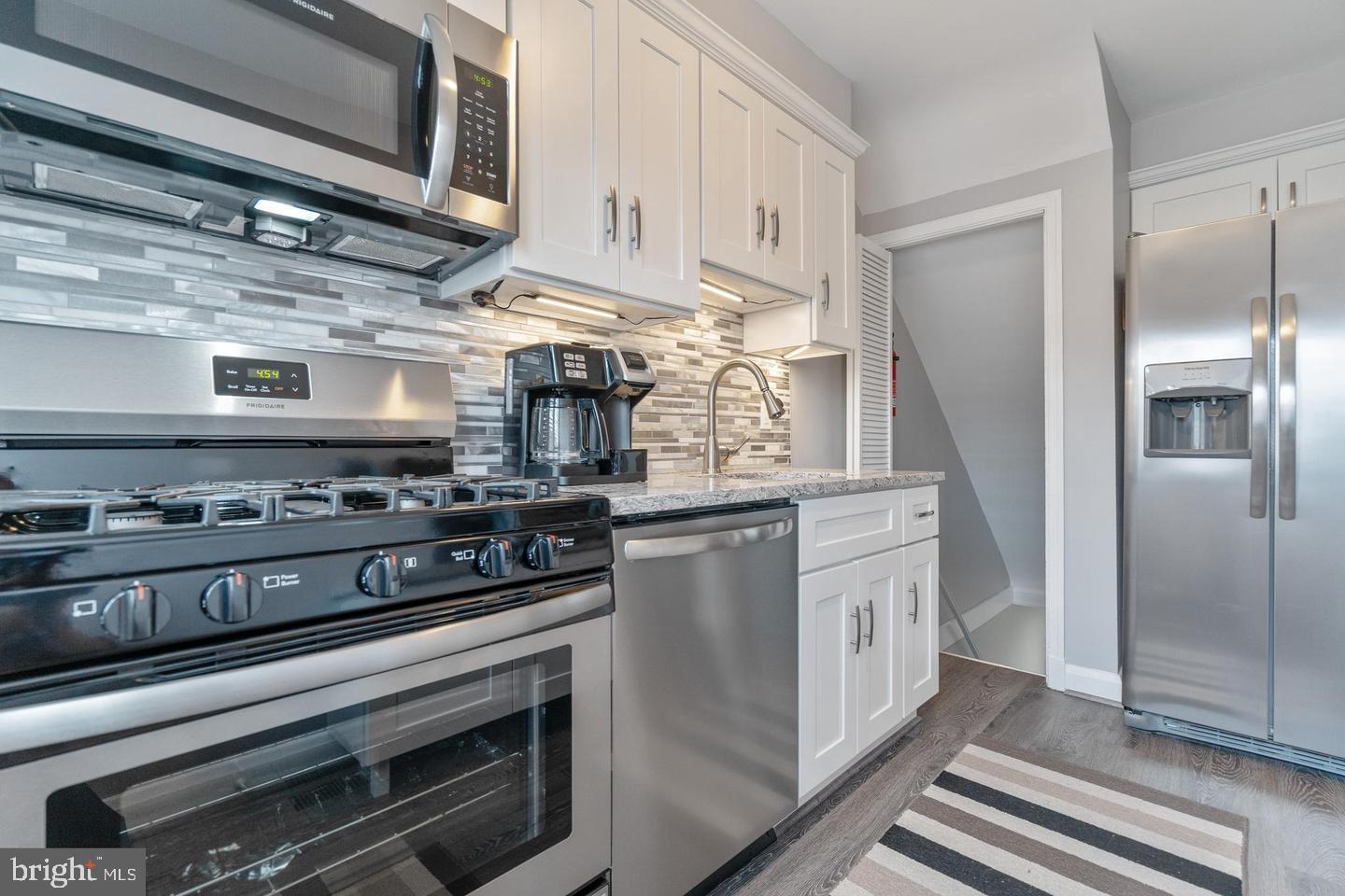 1067 Elm Road Halethorpe, MD 21227 - Photo 13 of 32 a kitchen with stainless steel appliances granite countertop a stove and a refrigerator