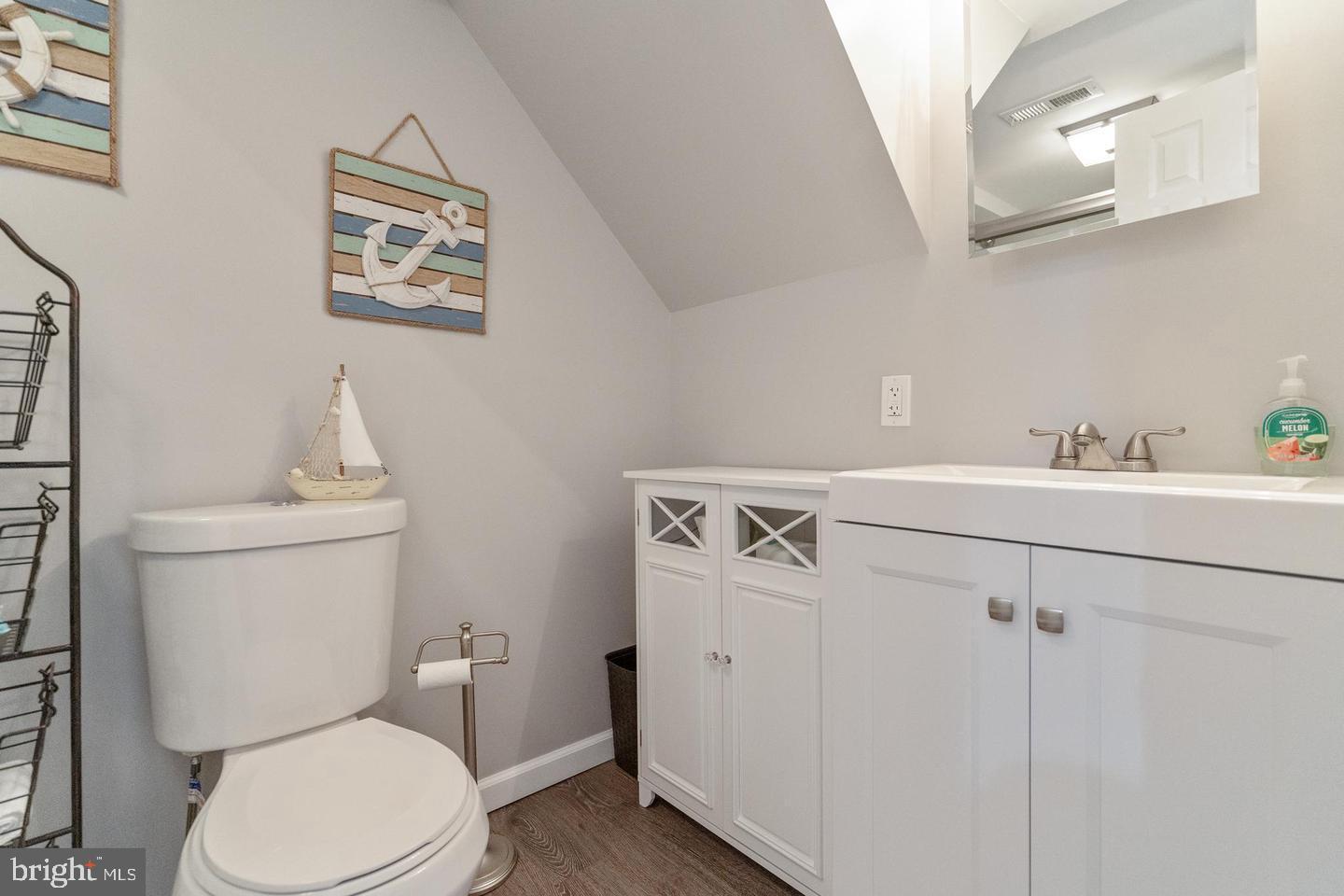 1067 Elm Road Halethorpe, MD 21227 - Photo 19 of 32 a bathroom with a toilet sink and mirror