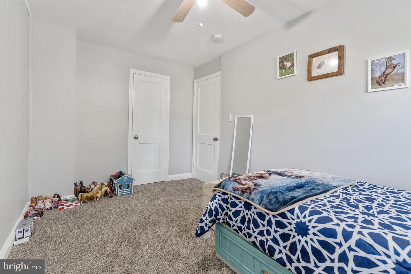 1067 Elm Road Halethorpe, MD 21227 - Photo 28 of 32 a bedroom with a bed and a chandelier