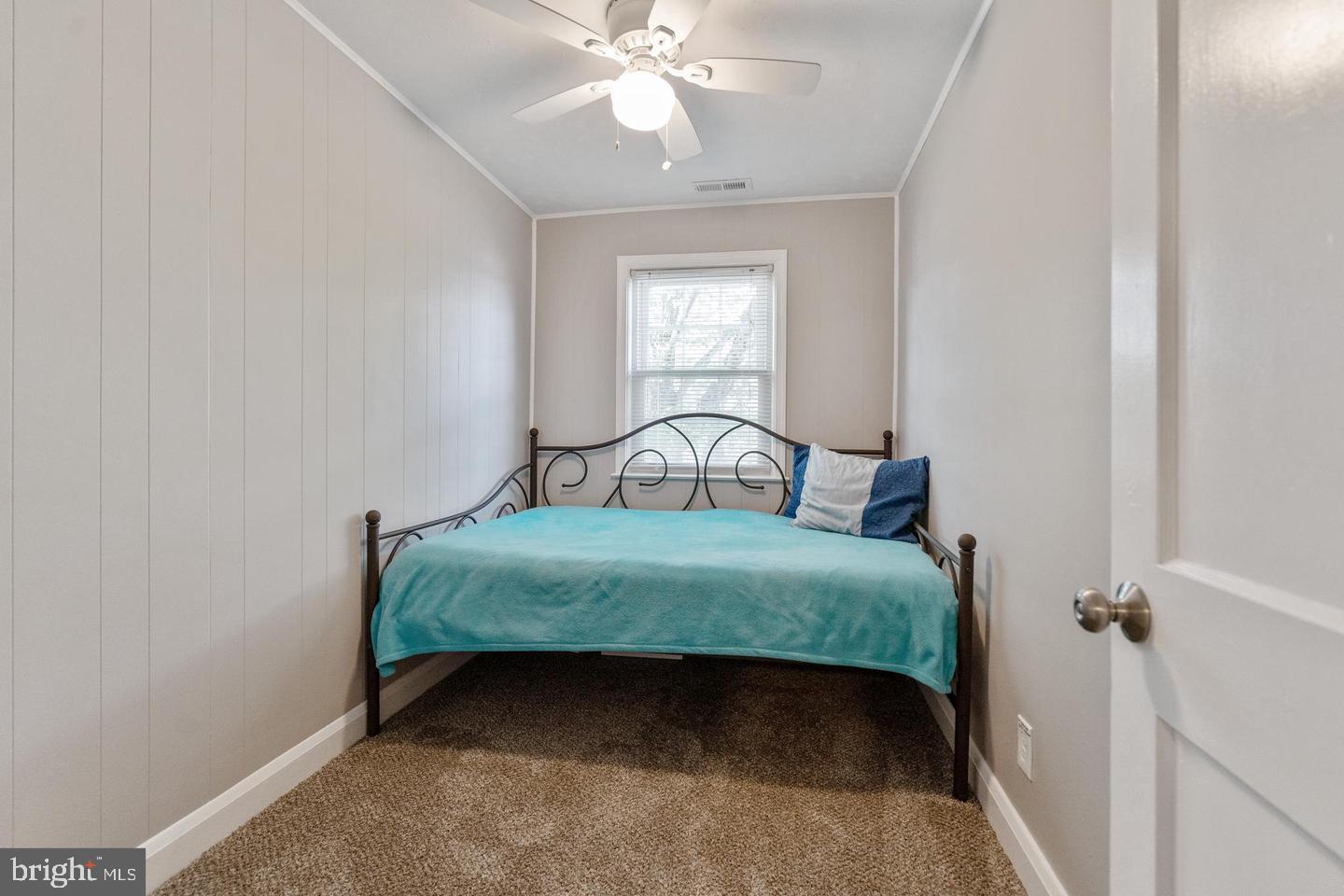 1067 Elm Road Halethorpe, MD 21227 - Photo 29 of 32 a bedroom with a bed window and a chandelier