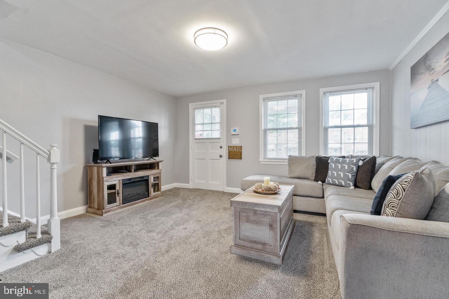 1067 Elm Road Halethorpe, MD 21227 - Photo 5 of 32 a living room with furniture and a flat screen tv
