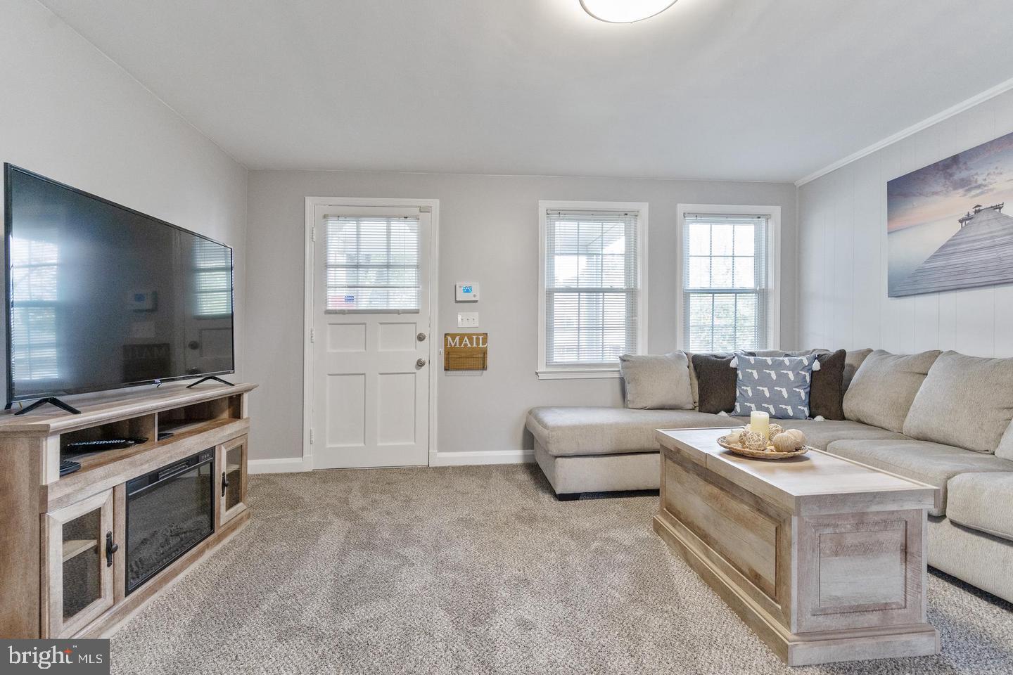 1067 Elm Road Halethorpe, MD 21227 - Photo 6 of 32 a living room with furniture and a flat screen tv