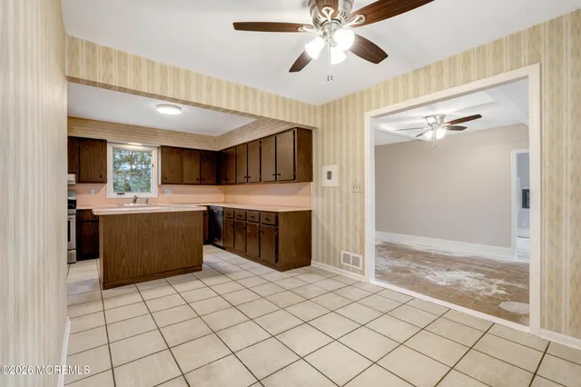 a kitchen with stainless steel appliances a sink and a refrigerator