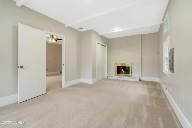a view of empty room with a fireplace