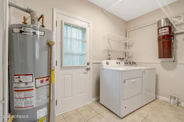 a utility room with cabinets washer and dryer