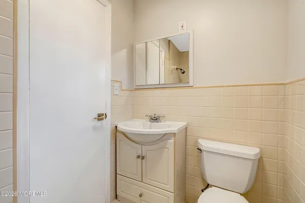 a view of a big room with wooden floor and windows