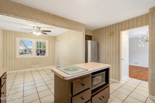 a kitchen that has a sink and a stove top oven
